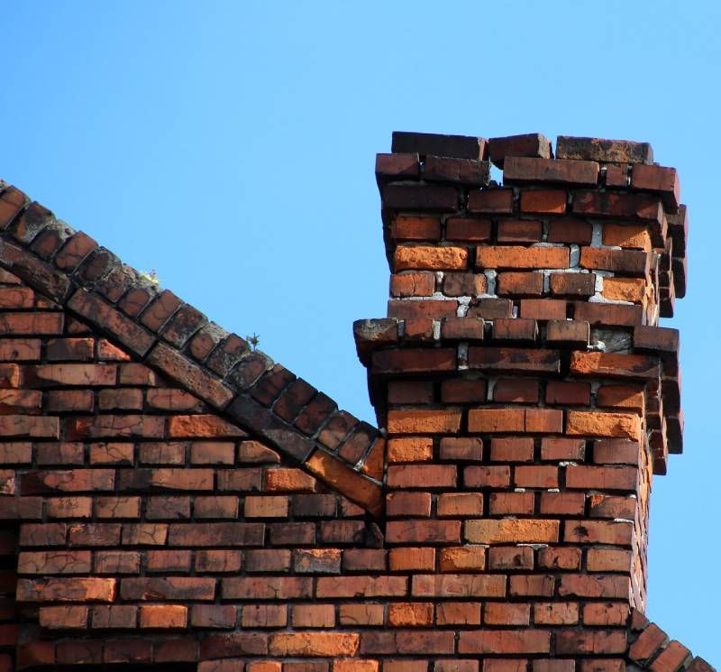 Damaged chimney on an Willow Springs home showing cracks and missing mortar